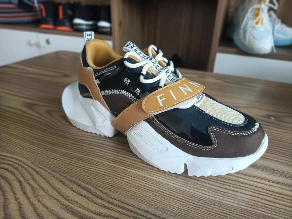Running sneaker prototype on a wooden table