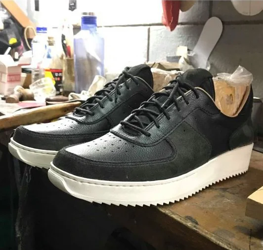Final PAMBA prototype pair in black leather and suede on lasts at the workshop